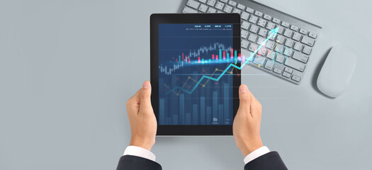 Business plan graph growth  increase of chart positive indicators in his business,tablet in hand