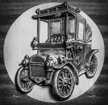 An image of an old car model on minting in black and white photo.
