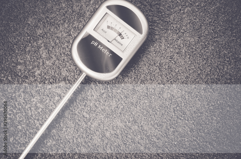Poster top view closeup of an analog tool to measure the ph of the soil on a toned rough stone surface