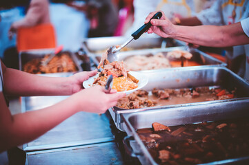 Volunteers give food to the poor: concept of charity food for the poor