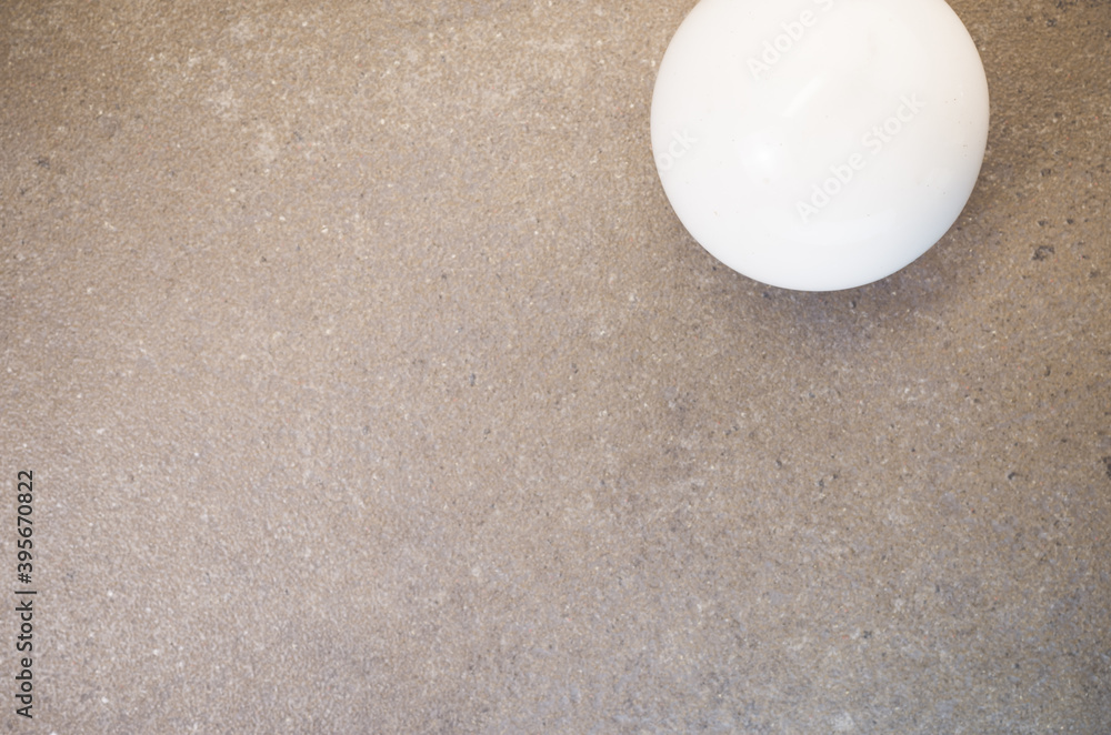 Poster top view of white ball on a rough-textured surface with copy space