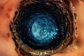 Front view looking inside a flexible pipe with thermal fiberglass insulation wrapping