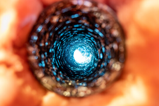 Front View Looking Inside A Flexible Pipe With Thermal Fiberglass Insulation Wrapping