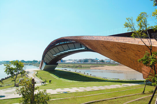 Pasan bridge over a river under the sunlight and a blue sky in Nakhon Sawan, Thailand