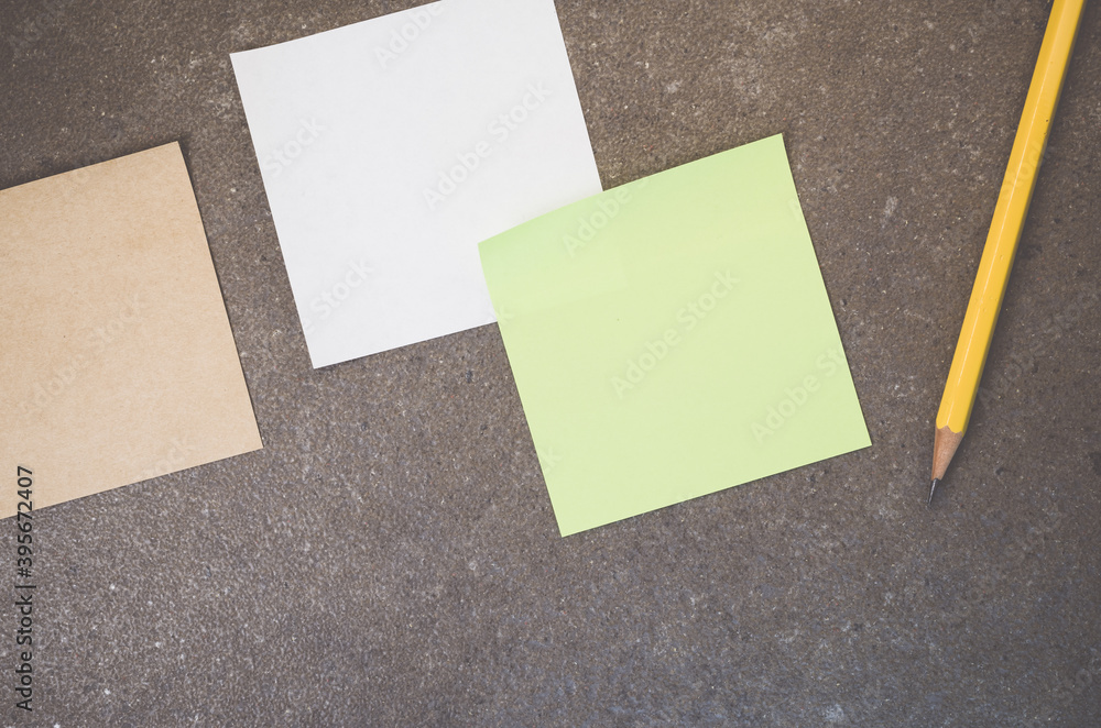 Aufkleber top view of blank paper memos with pencil on a rough-textured surface with copy space