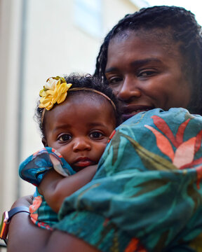 Beautiful, loving African American mother with infant daughter