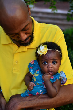 Loving African American father with beautiful infant daughter