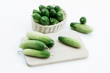 Cucumber fresh on basket and cutting board on the white table background for cooking ingredient in food healthy.