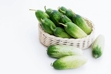 Cucumber fresh in basket and on the white table background for cooking ingredient in food healthy.