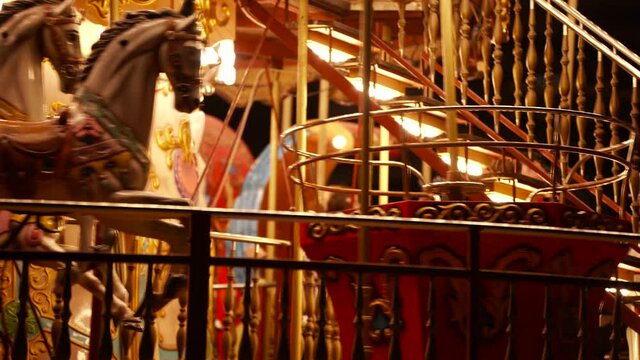 Carousel roundabout or merry-go-round with children having fun at festive night