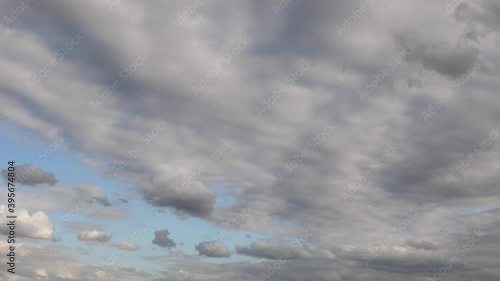 Wall mural white clouds of different shapes and sizes fly in time lapse fashion over a vivid blue sky on a part