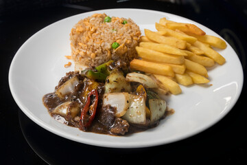 Beef in black bean sauce served with fried rice and French fries