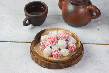 Klepon merah putih. Red and White Klepon is indonesian traditional food made of glutinous rice flour which is shaped like small balls with palm sugar filling and covered with grated coconut.