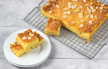 Prol Tape or bolu tapai , traditional dessert originated from Indonesia. Made from fermented cassava, topping with grated cheese and almond decorated with edible flower viola.