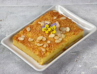 Prol Tape or bolu tapai , traditional dessert originated from Indonesia. Made from fermented cassava, topping with grated cheese and almond decorated with edible flower viola.