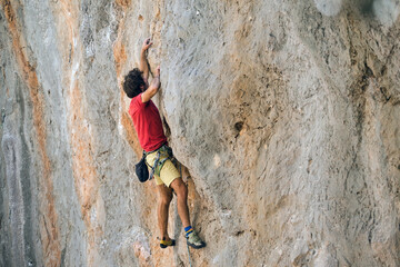Fototapeta premium A climber is training on a natural terrain.