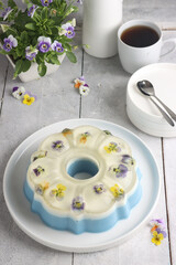 Puding bunga. Edible flower pudding. On the top side, clear pudding with edible flower, Middle part is milk flavor and the bottom side is butterfly pea flavor.