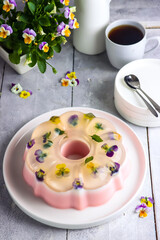 Puding bunga. Edible flower pudding. On the top side, clear pudding with edible flower, Middle part is milk flavor and the bottom side is strawberry flavor.