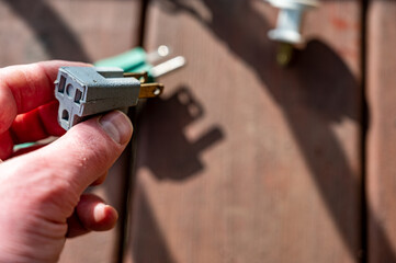 Demonstrating using a 3-prong adapter to connect two power cords