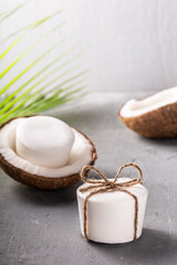 Handmade coconut soap bar white color on grey concrete background.