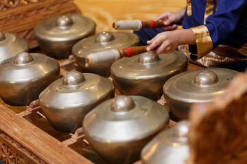 Cropped image of a musician playing gongs, Traditional Malaysian musical instruments.