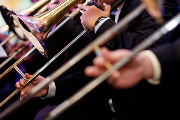 Detail of a trombone in the hands of the musician closeup