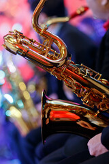 Detail of a saxophone in the hands of the musician closeup