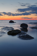 Fototapeta na wymiar Late summer sunset on shore of the Baltic Sea , rocky coast. Estonia.