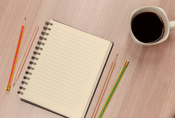 Top view close up notebook with pencil and coffee cup