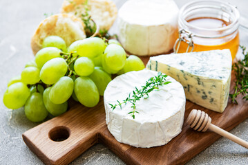 Cheese selection, honey and grape