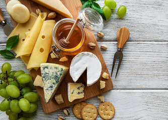 Various types of cheese  on a white wooden  background