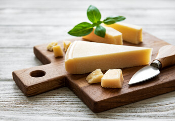 Piece of parmesan cheese on a wooden board