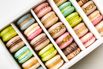 Colourful french macaroons on white background. Top view