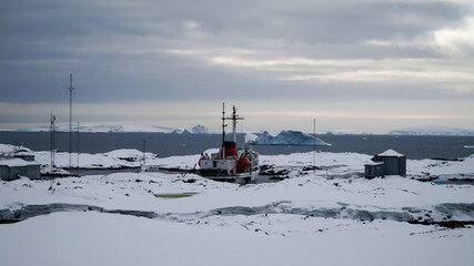 Icebergs and snow capped mountains in the Antarctic Peninsula after passing the Lemaire Channel in...