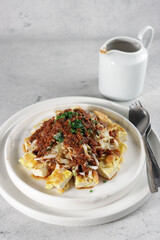 Tahu telur or egg tofu omelet with peanut sauce, bean sprouts and cabbage slices.