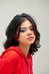 Fototapeta premium Beautiful woman with volume and shiny curly hair style, bright make-up
