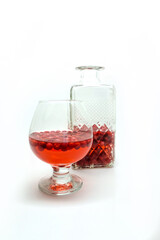 Homemade tincture of red cherry. Berry alcoholic drinks concept. Homemade red wine made from ripe cherries in a glass bottle
