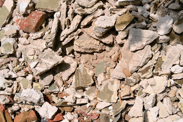 Construction debris from destroyed walls on the ground close-up. A pile of concrete, rubble and debris.