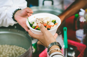 Poor people get free food from volunteers: Concept serving free food to the poor