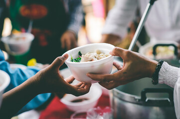 Homeless people pick up charity food from the food donors in society: The concept of the beggar