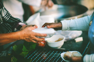 The hands of poor have been aided by charity food to alleviate hunger: The concept of social sharing