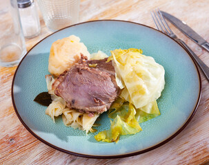 Pork cheeks with stewed cabbage leaves. Spanish cuisine