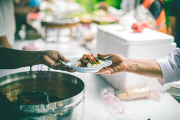 The Hand of the Beggars receives charity food from fellow human beings: Concepts of feeding