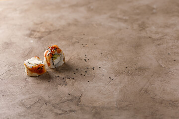 Appetizing rolls on a textured background. Japanese food concept. Close-up. Copy space.