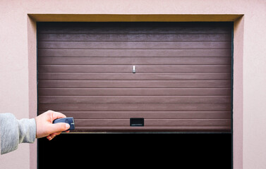 Garage door PVC. Hand use remote controller for closing and opening garage door

