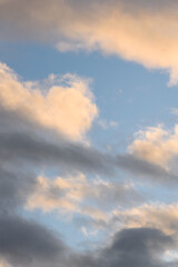 Fototapeta premium Colorful blue sky and clouds highlighted by setting sun, as a nature background 
