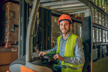Young bearded worker in yellow vest smiling and looking positive
