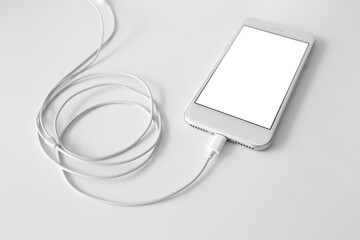 Mobile phone with earphones on white background