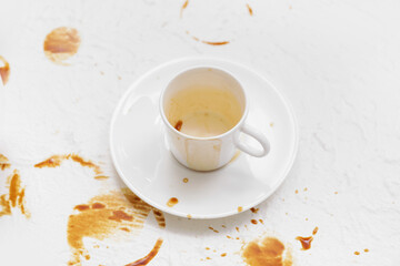 Cup and coffee stain on light background