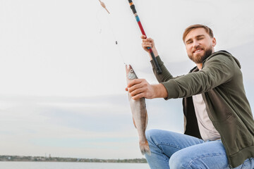 Young man fishing on river